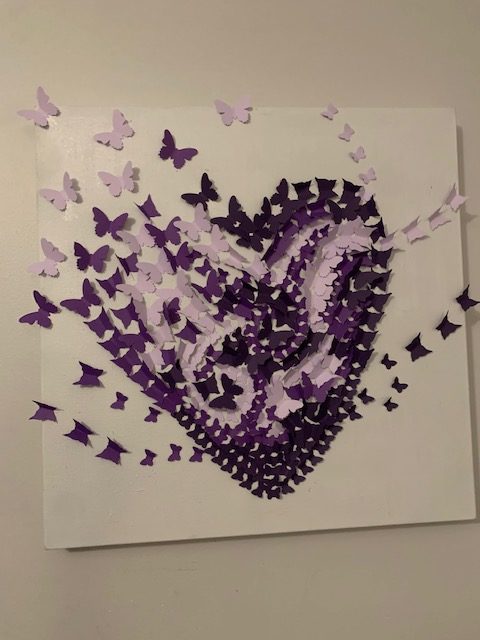 A purple heart made of butterflies.
