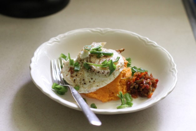 bowl with sweet potato, egg, and onions.