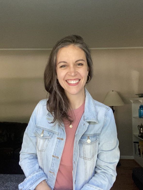 Kristen in a denim jacket, smiling at the camera.