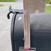 Mailbox with a faded flag.
