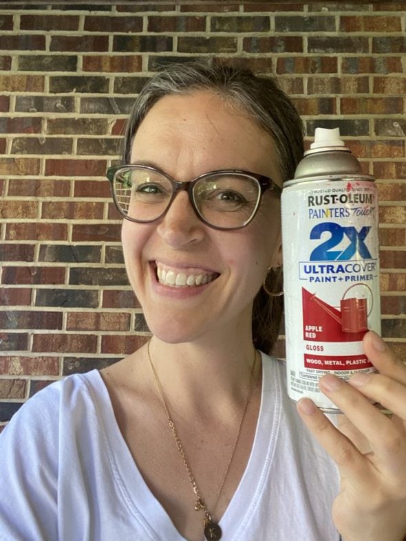 Kristen holding a can of spray paint.