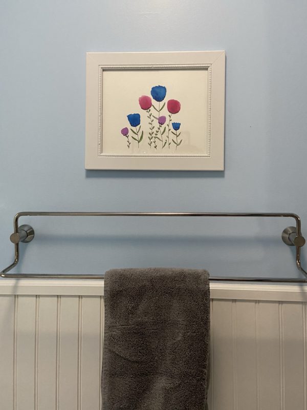 framed wateroclor art on bathroom wall.