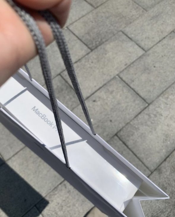 macbook in shopping bag.