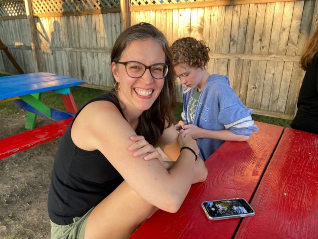 Kristen sitting at a picnic table.