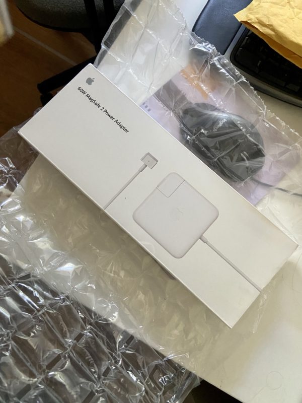 Apple laptop charger in box.