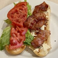 BLT sub on a white plate.