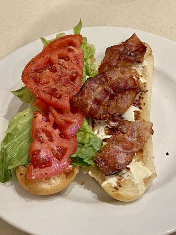 BLT sub on a white plate.