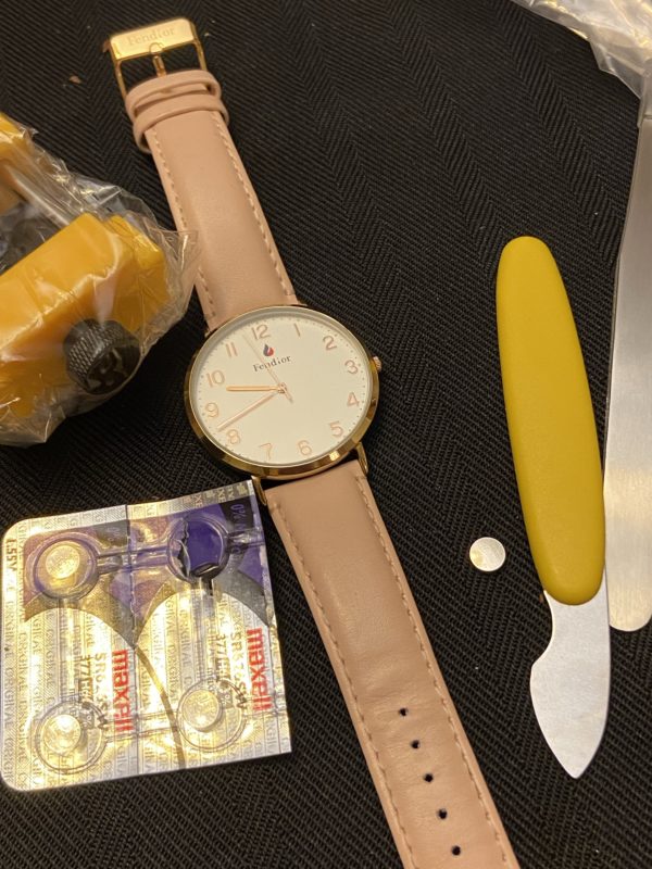 a watch repair kit and a pink watch.