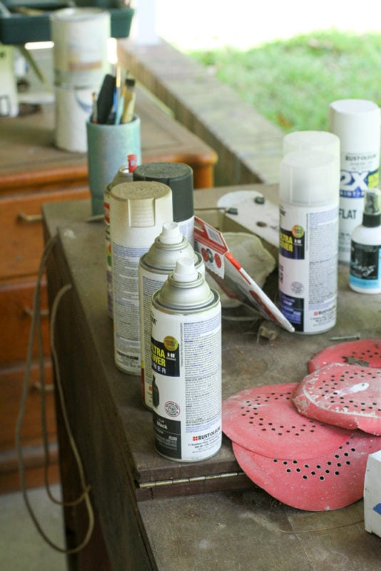 cans of spray paint on a table.