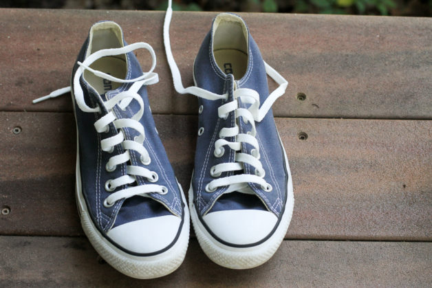 replacement laces in a pair of blue converse.