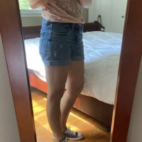 Kristen wearing a pair of blue Converse.