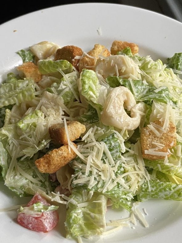 Caesar salad on a white plate.