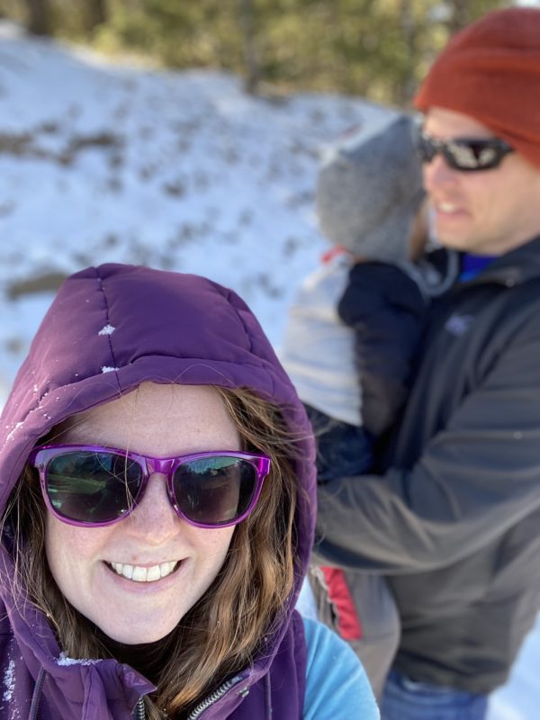 Kaitlin in the snow, with sunglasses.