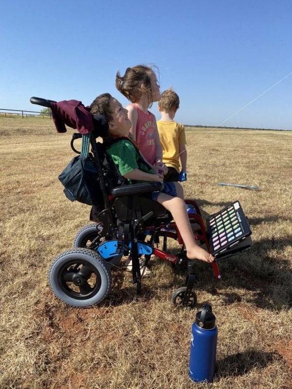 Kaitlin's three kids in a field.