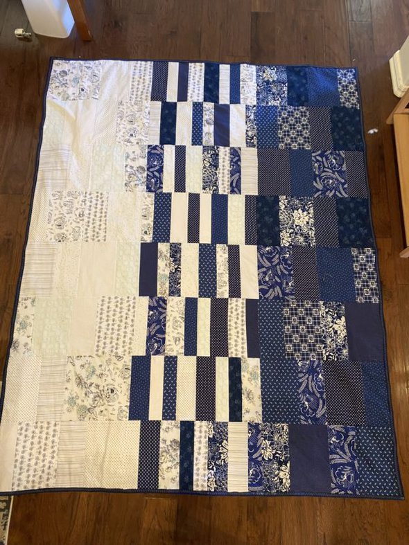 A blue and white handmade quilt.