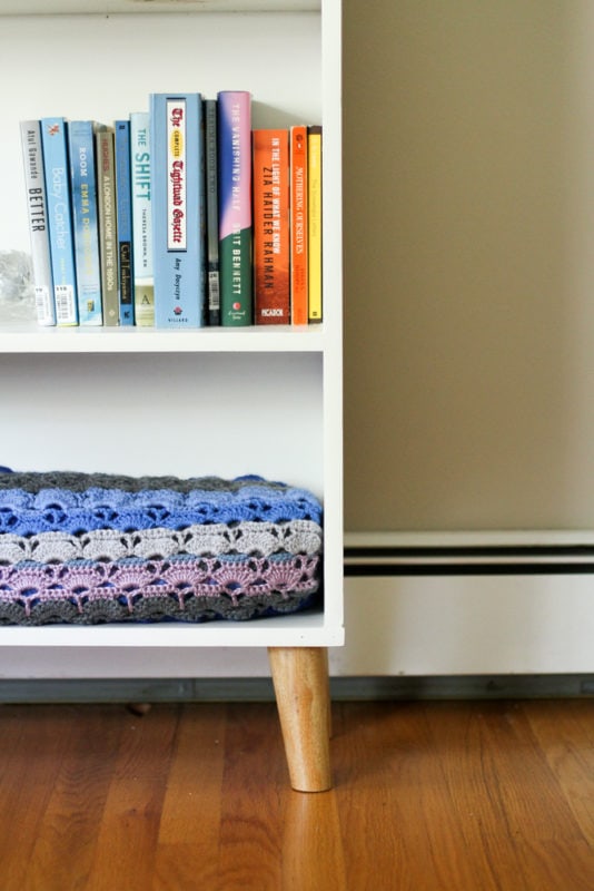 wooden legs on bookshelf.