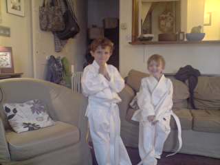 Two kids in judo uniforms.