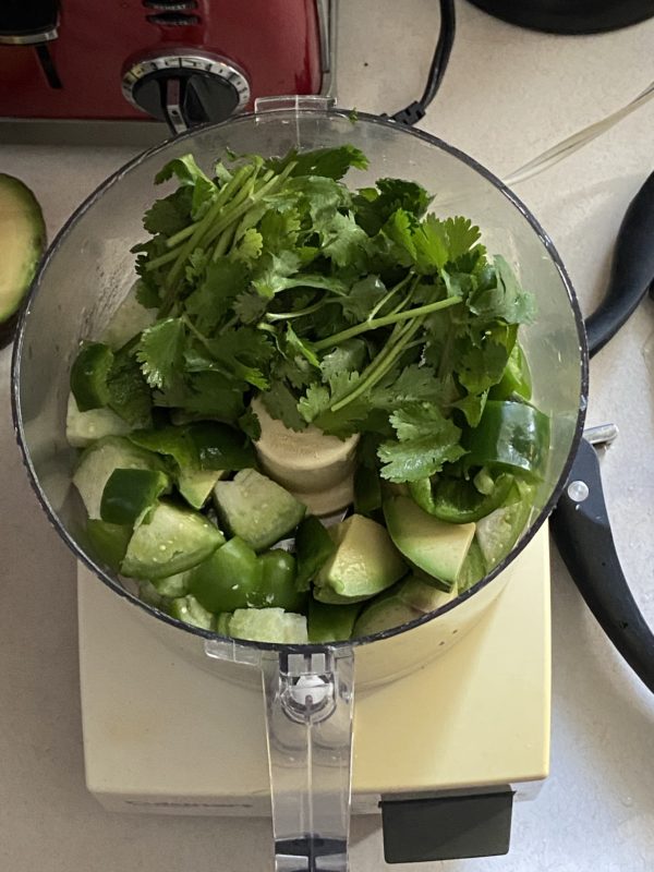 tomatillo salsa ingredients in a food processor.