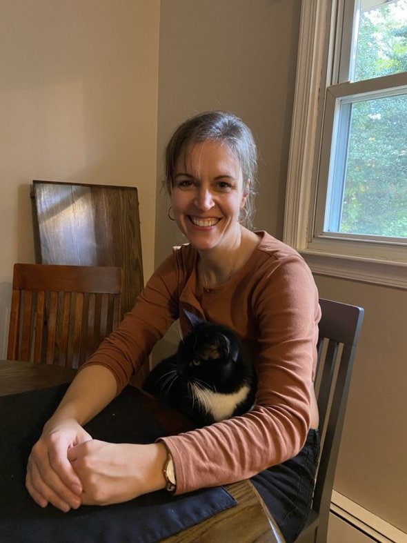 Kristen with her cat on her lap.