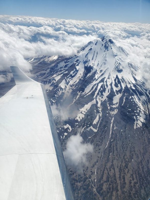 snowy mountains viewed from a plane window.