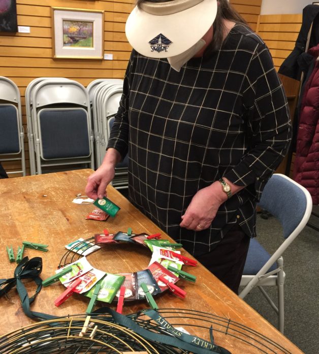 woman making a teabag wreath.