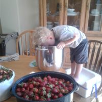 a kid helping to make jam.