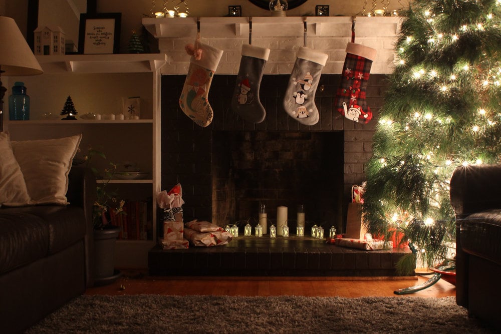 four stockings hanging on a mantel.