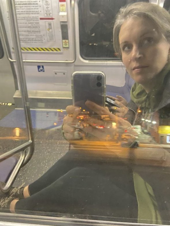Kristen's reflection in a train window.