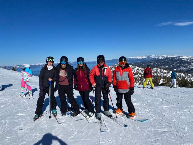 Kristen's family on top of a ski run.