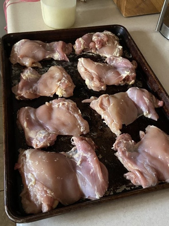 chicken thighs on a baking sheet.
