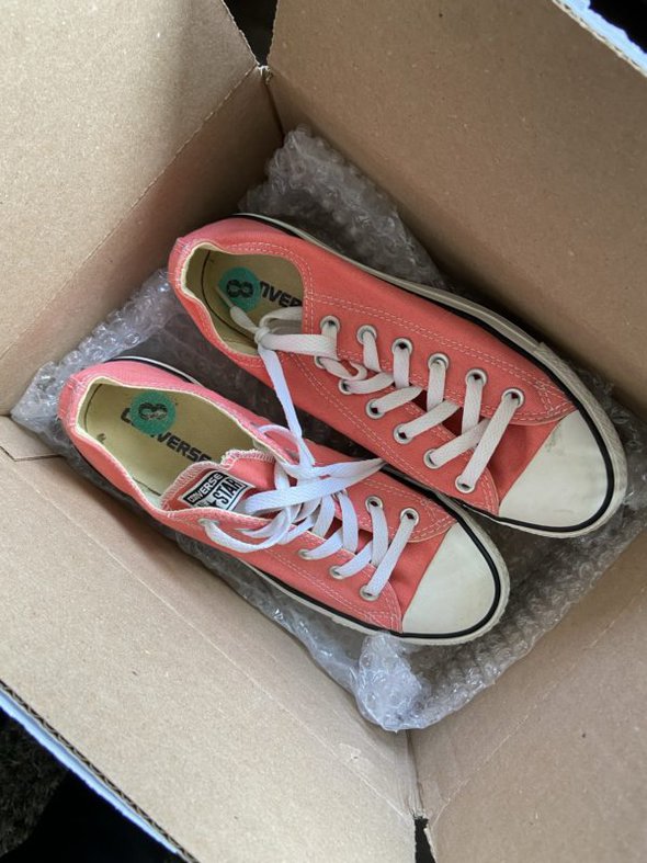 Converse in a shipping box.