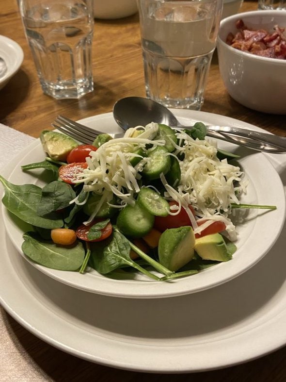 green salad in a white bowl.