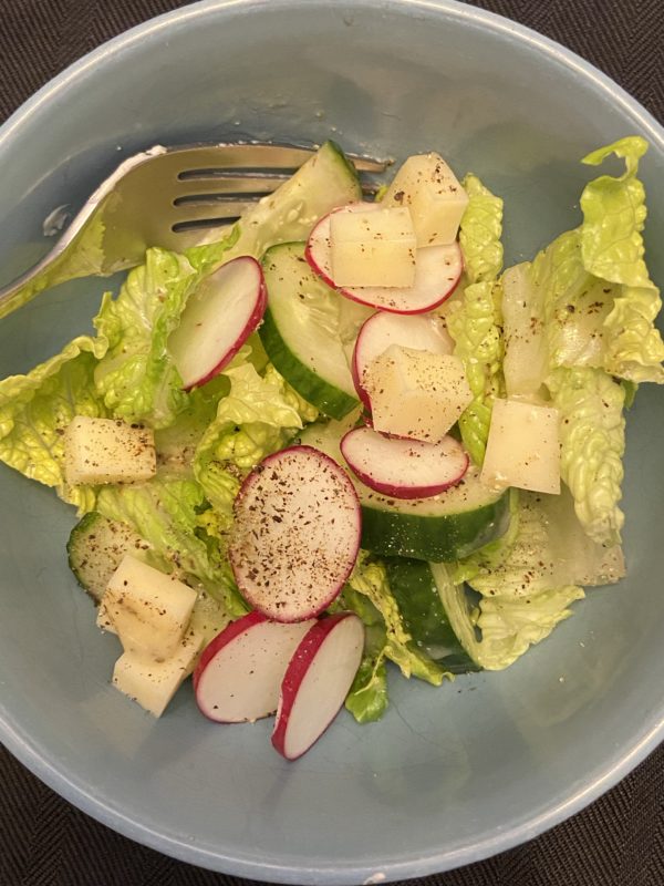 green salad in a blue bowl.