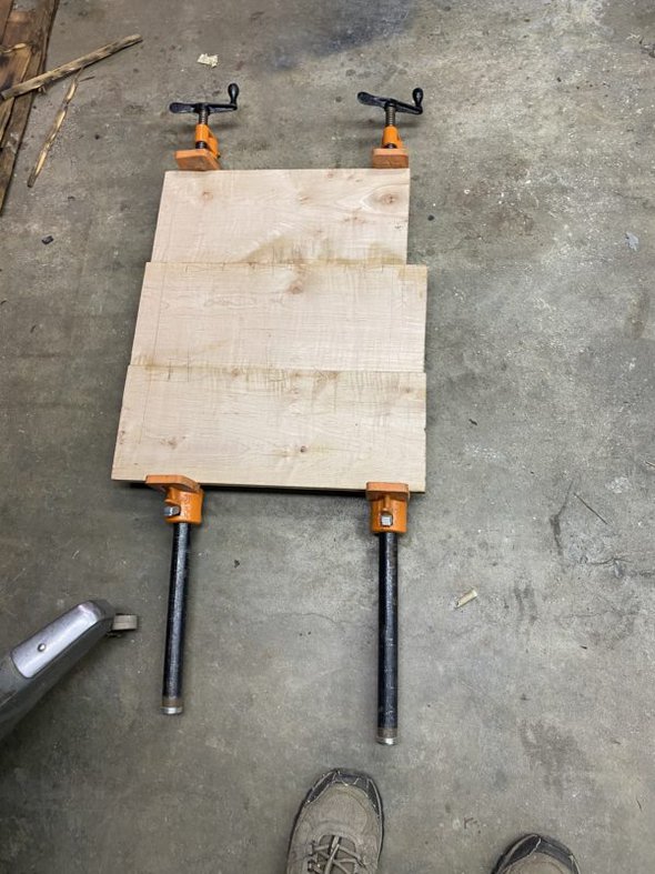 three pieces of clamped wood.