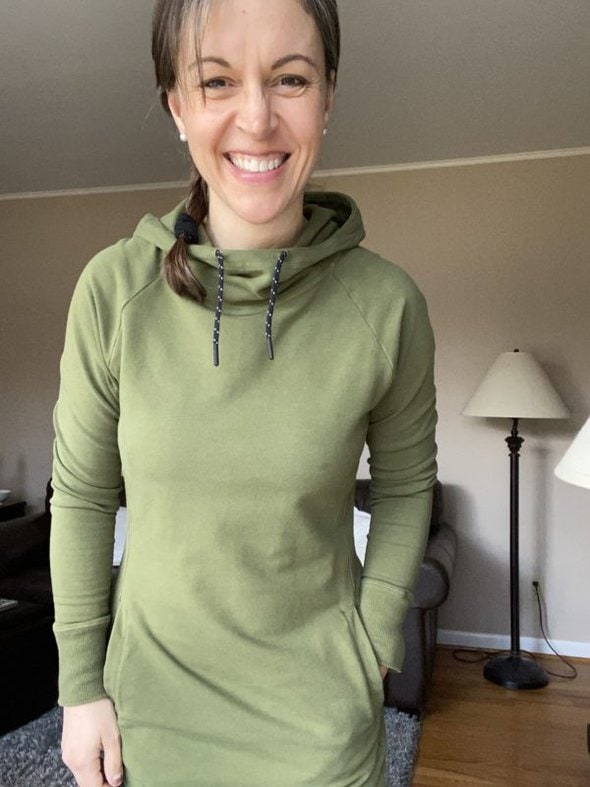 Kristen in a green hoodie dress.