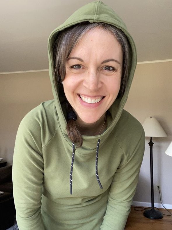 Kristen with a green hood on.