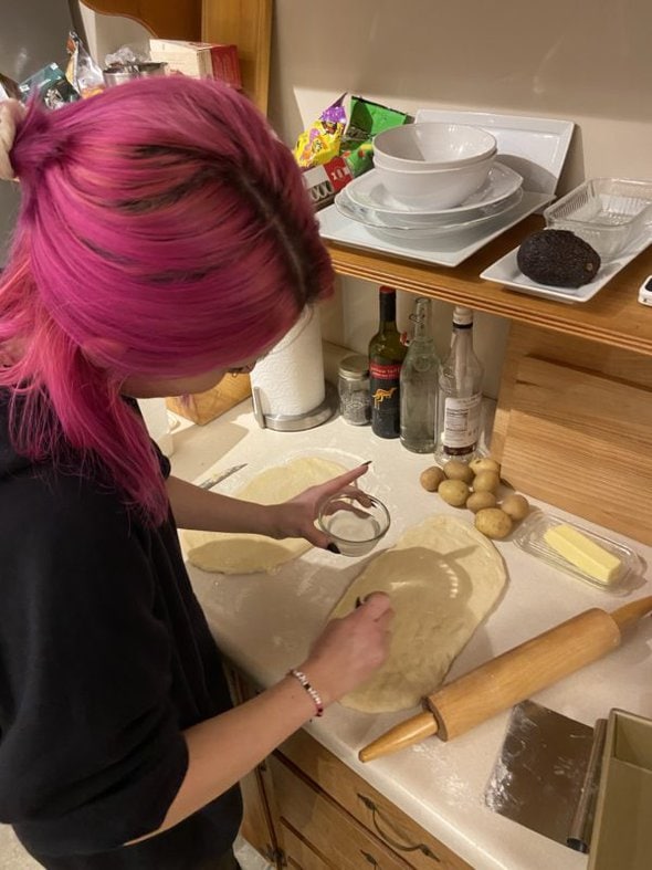 Lisey brushing bread with water.