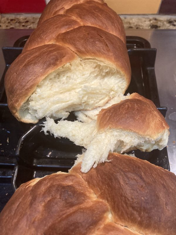 torn loaf of braided bread.