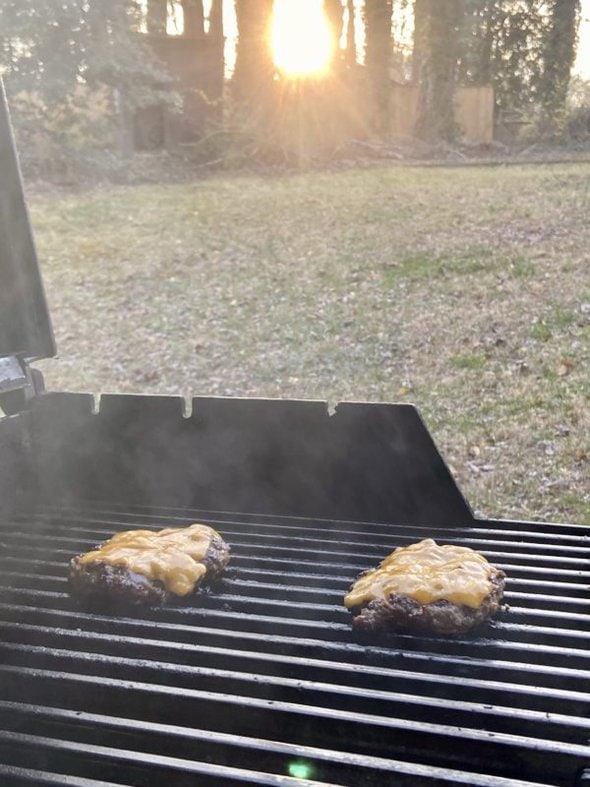 cheeseburgers on grill.