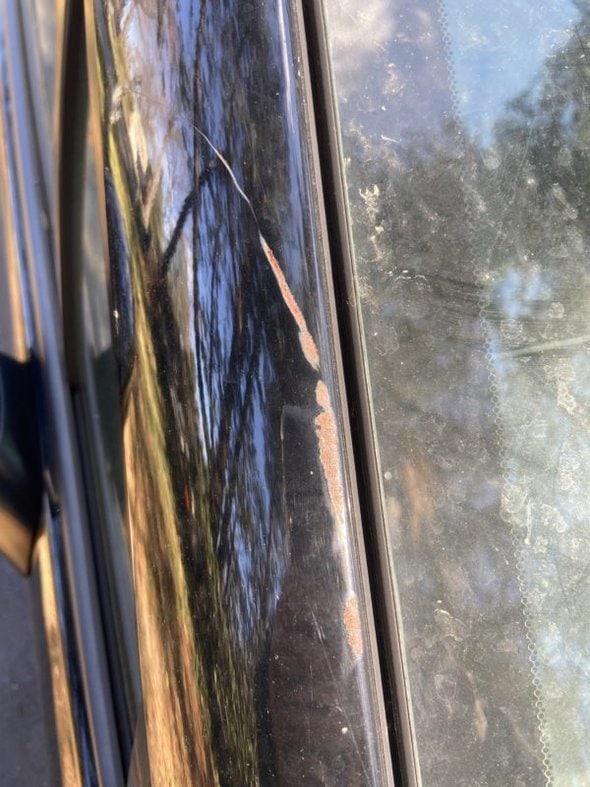 rusted scrape on black car.