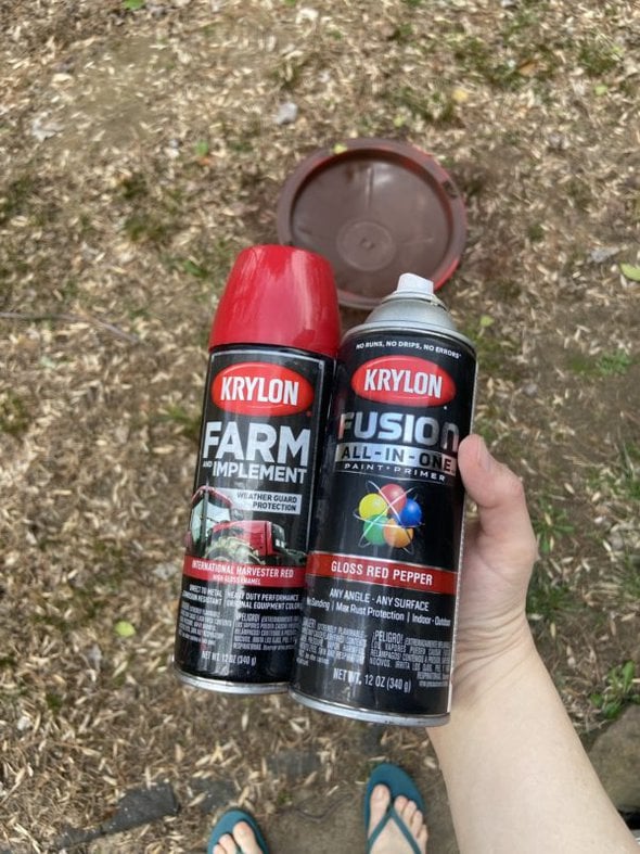 two cans of red spray paint.