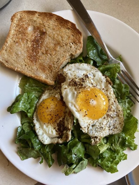 fried eggs on greens.
