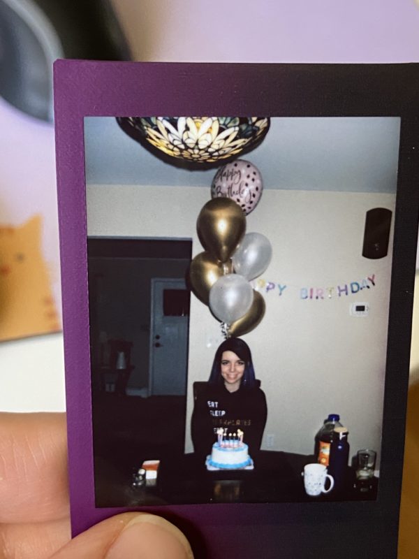 Polaroid of Lisey with birthday cake.