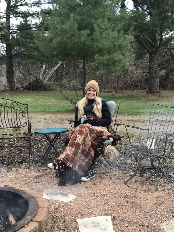 Maureen by a fire pit.