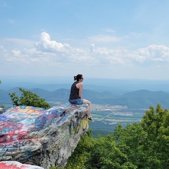 Sarah on a rock cliff.