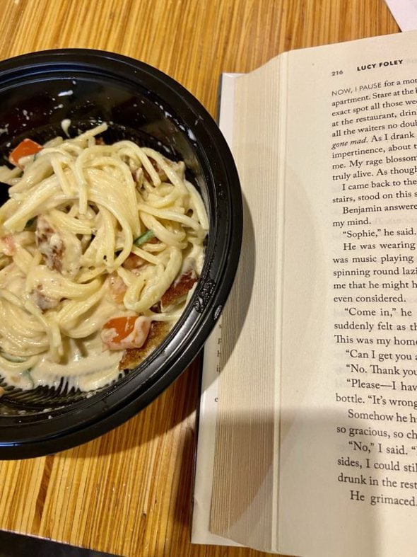 noodle bowl next to a book.