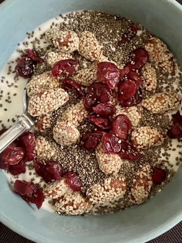 yogurt topped with fruit and seeds.