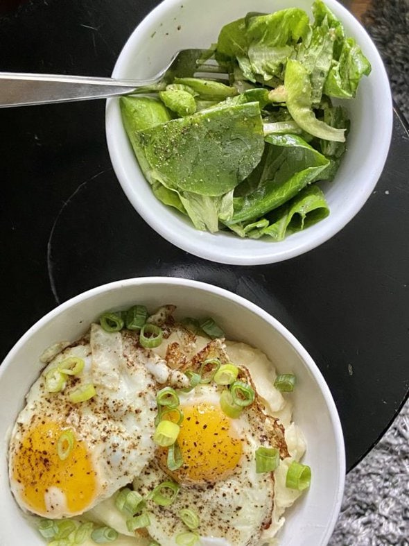 salad greens in a white bowl.