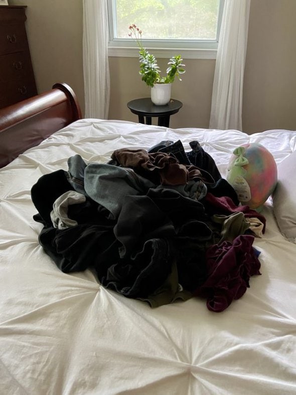 laundry pile on bed.