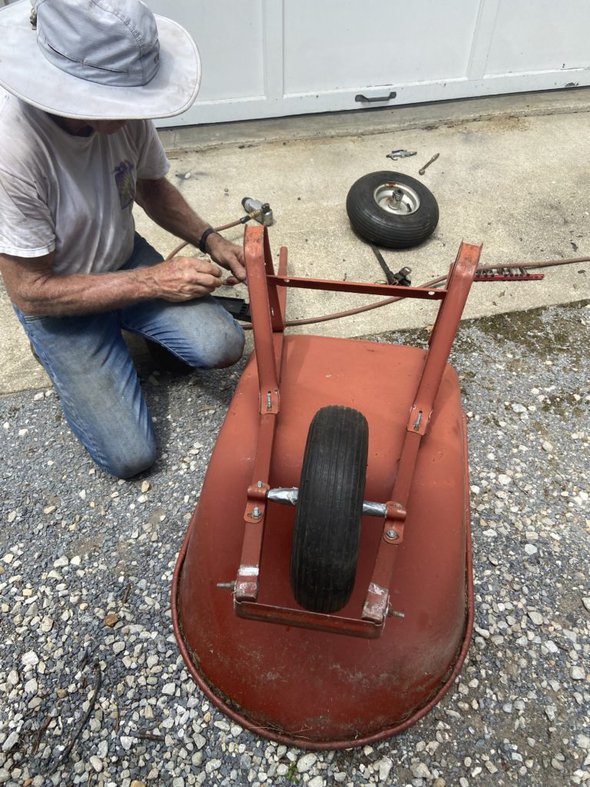 Kristen's dad next to the wheelbarrow.